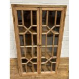 A PINE CABINET WITH 'CRISS CROSS' GLAZED DOORS, 76cm x 46cm x 29cm