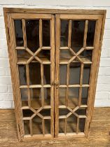 A PINE CABINET WITH 'CRISS CROSS' GLAZED DOORS, 76cm x 46cm x 29cm