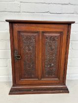 AN INDIAN TABLE TOP CABINET WITH CARVED PANELS AND DOOR 50cm x 41cm x 16cm