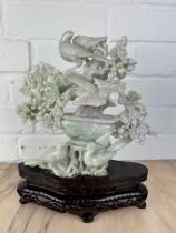 A CHINESE JADE GROUP OF BIRDS ON BRANCHES ON ROSEWOOD STAND, Probably 20th century or modern. The