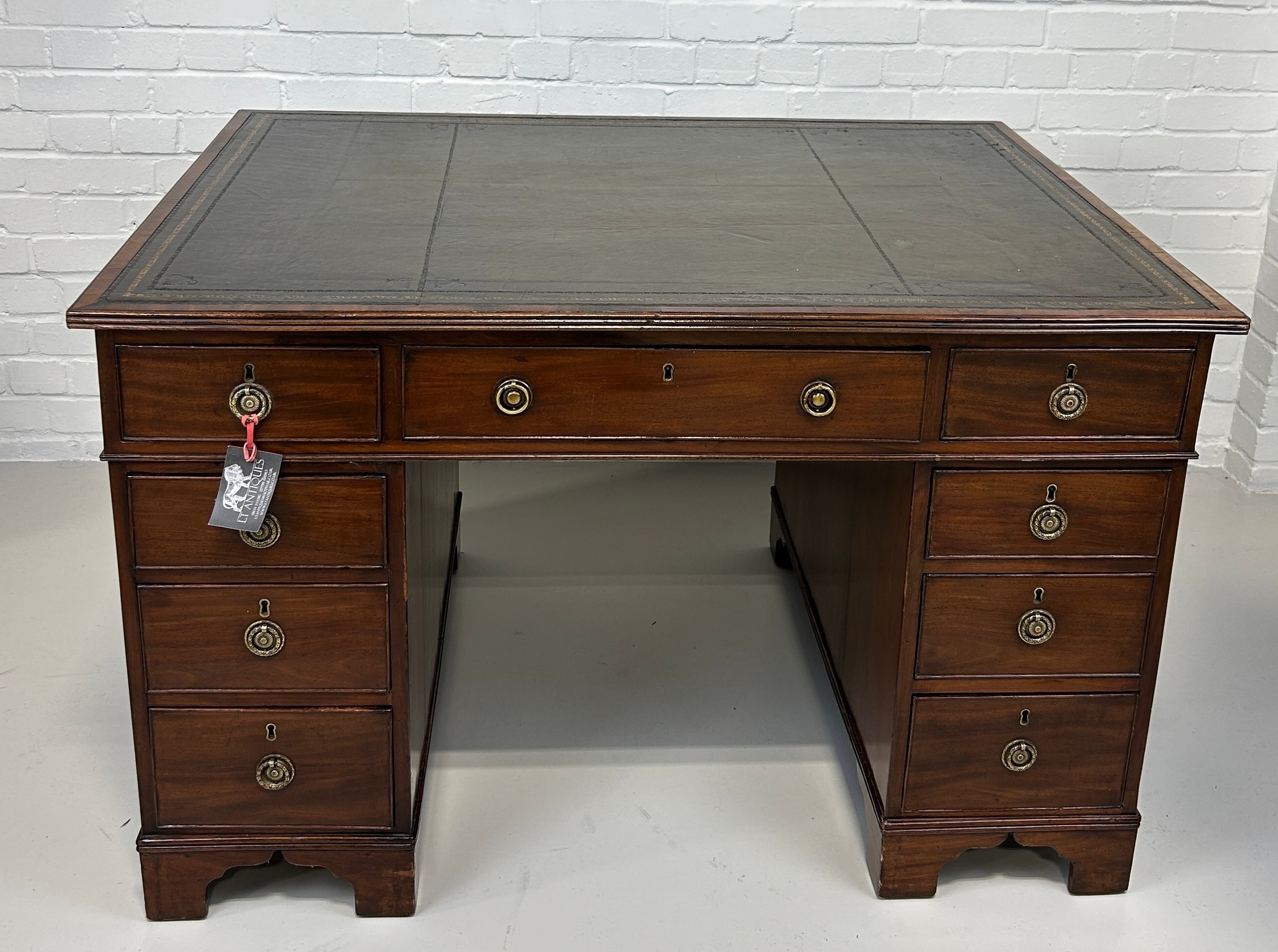 AN EARLY 19TH CENTRAL PARTNERS DESK, Two pedestals, each with ten drawers with brass handles.