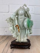 A CHINESE JADE FIGURE OF A LUOHAN ON ROSEWOOD STAND, Probably 20th century or modern. Jade 24cm x