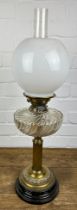 A BRASS OIL LAMP WITH GLASS SHADE,