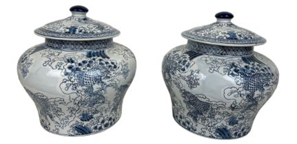 A PAIR OF LARGE CHINESE 'CARP' DESIGN LIDDED JARS, 34cm x 34cm each.