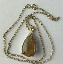 A LARGE BLACK PEARL SHAPED OPAL IN 9CT GOLD WITH 9CT GOLD CHAIN, Weight 4.7gms Opal 1.7cm x 1.4cm