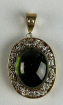 A LARGE GREEN TOURMALINE CIRCA 7 CARATS SURORUNDED BY DIAMOND GALLERY, Weight 17.6gms