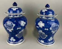 A PAIR OF CHINESE PRUNUS JARS AND COVERS, 28cm H each.