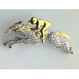 AN 18CT GOLD AND DIAMOND HORSE AND JOCKEY BROOCH, The brooch measures 4.7cm x 2.4cm.