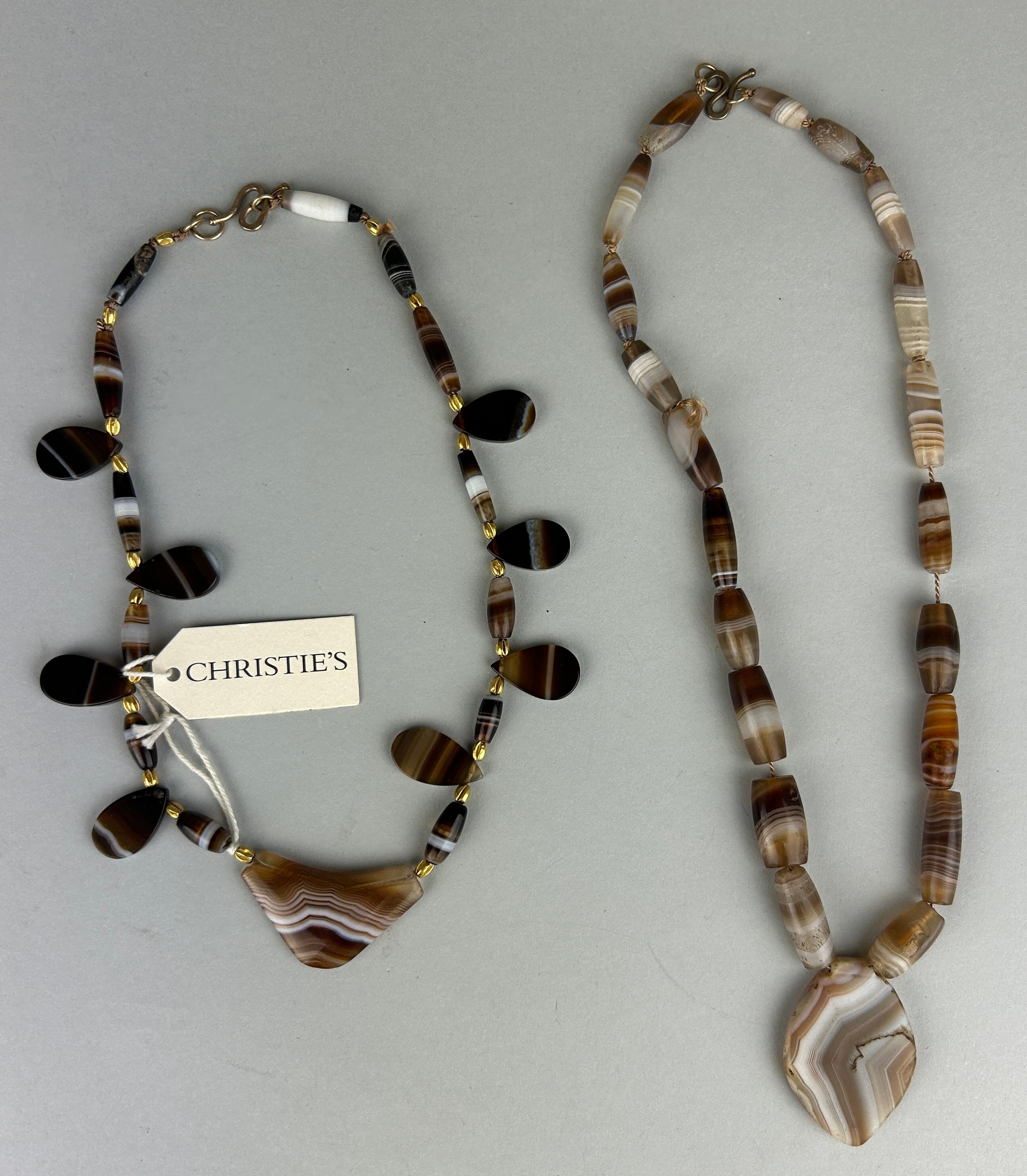 A WESTERN ASIATIC BANDED AGATE BEAD NECKLACE CIRCA 3RD MILLENIUM B.C. / 2ND CENTURY A.D. ALONG