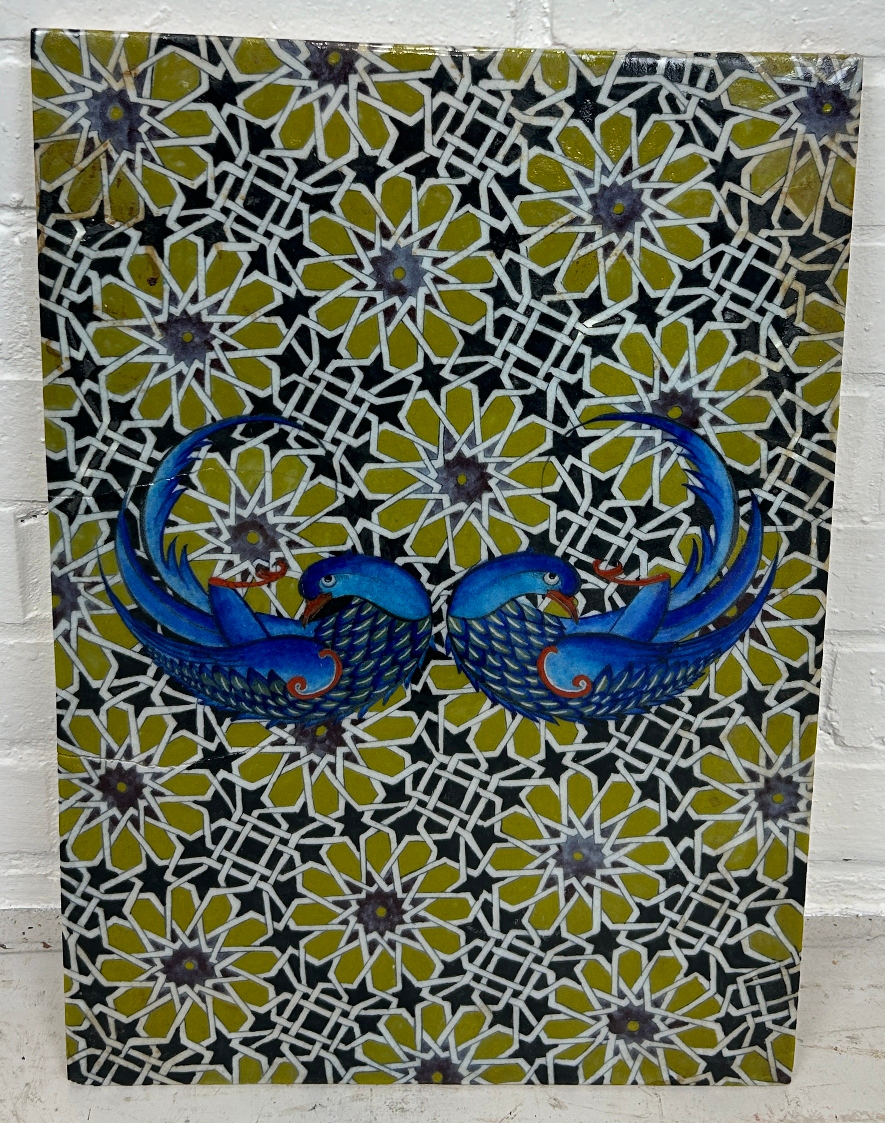 A PERSIAN TILE DECORATED WITH BIRDS AND FLOWERS, 49cm x 34cm