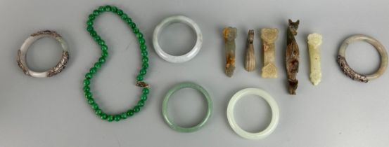 A COLLECTION OF FIVE CHINESE JADE OR STONE BANGLES ALONG WITH FIVE BELT HOOKS SOME IN THE ARCHAIC