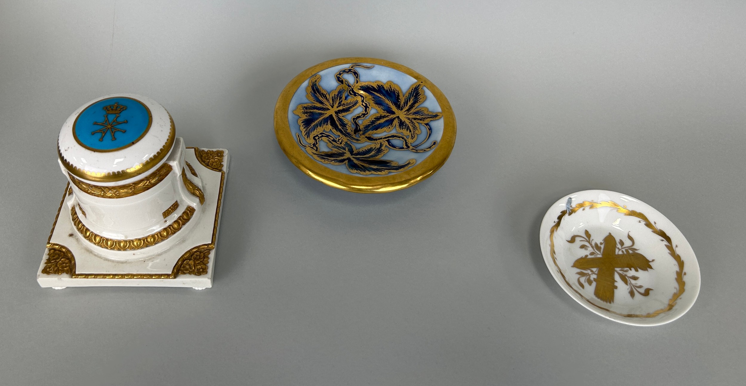 A KPM PORCELAIN AND GILT DESK INKWELL WITH ROYAL EMBLEM, Along with two Limoges dishes Inkwell