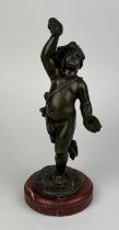 A 19TH CENTURY FRENCH BRONZE SCULPTURE OF A PUTTI AFTER CLAUDE CLODION (1738-1814) ON A RED MARBLE