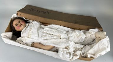 A LATE 19TH OR EARLY 20TH CENTURY WAX DOLL, 70cm L Housed in Harrods box.