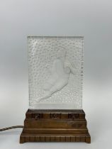 AN ART DECO VERLYS PRESSED GLASS LIGHT ON STAND IN THE FORM OF A RUGBY PLAYER, 30cm x 19cm