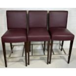 A SET OF THREE BAR STOOLS BY BEN WHISTLER UPHOLSTERED IN BURGUNDY LEATHER WITH WHITE BUTTON BACK,