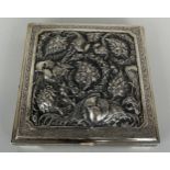 AN ANTIQUE PERSIAN SILVER BOX HAND CHASED REPOUSSE WITH FLOWERS AND BIRDS OF PARADISE, Hallmarked