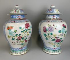 A PAIR OF CHINESE 19TH CENTURY BALUSTER VASES AND COVERS, 43cm x 25cm each. Enamelled with flowers