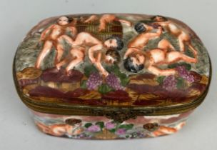 A CAPODIMONTE BOX DECORATED WITH PUTTI, Marked to verso. 15cm x 10cm x 8cm