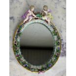 A MEISSEN PORCELAIN MIRROR WITH WINGED PUTTI CREST AND FLORAL BORDER, 34cm x 24cm