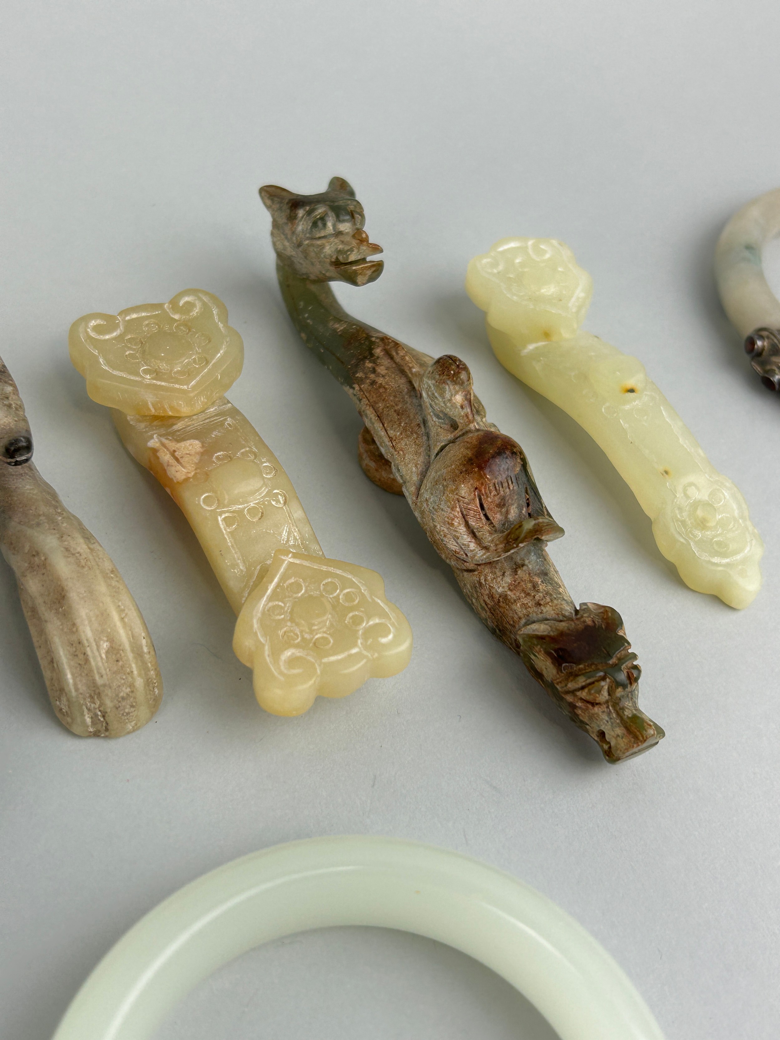 A COLLECTION OF FIVE CHINESE JADE OR STONE BANGLES ALONG WITH FIVE BELT HOOKS SOME IN THE ARCHAIC - Image 4 of 5