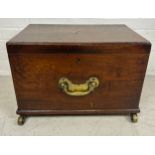 A GEORGE III MAHOGANY CELLARETTE, With fitted interior, brass handles and brass castors. 54cm x 38cm