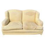 A HOWARD STYLE HUMPBACK SOFA UPHOLSTERED IN YELLOW FABRIC, 176cm x 105cm x 93cm