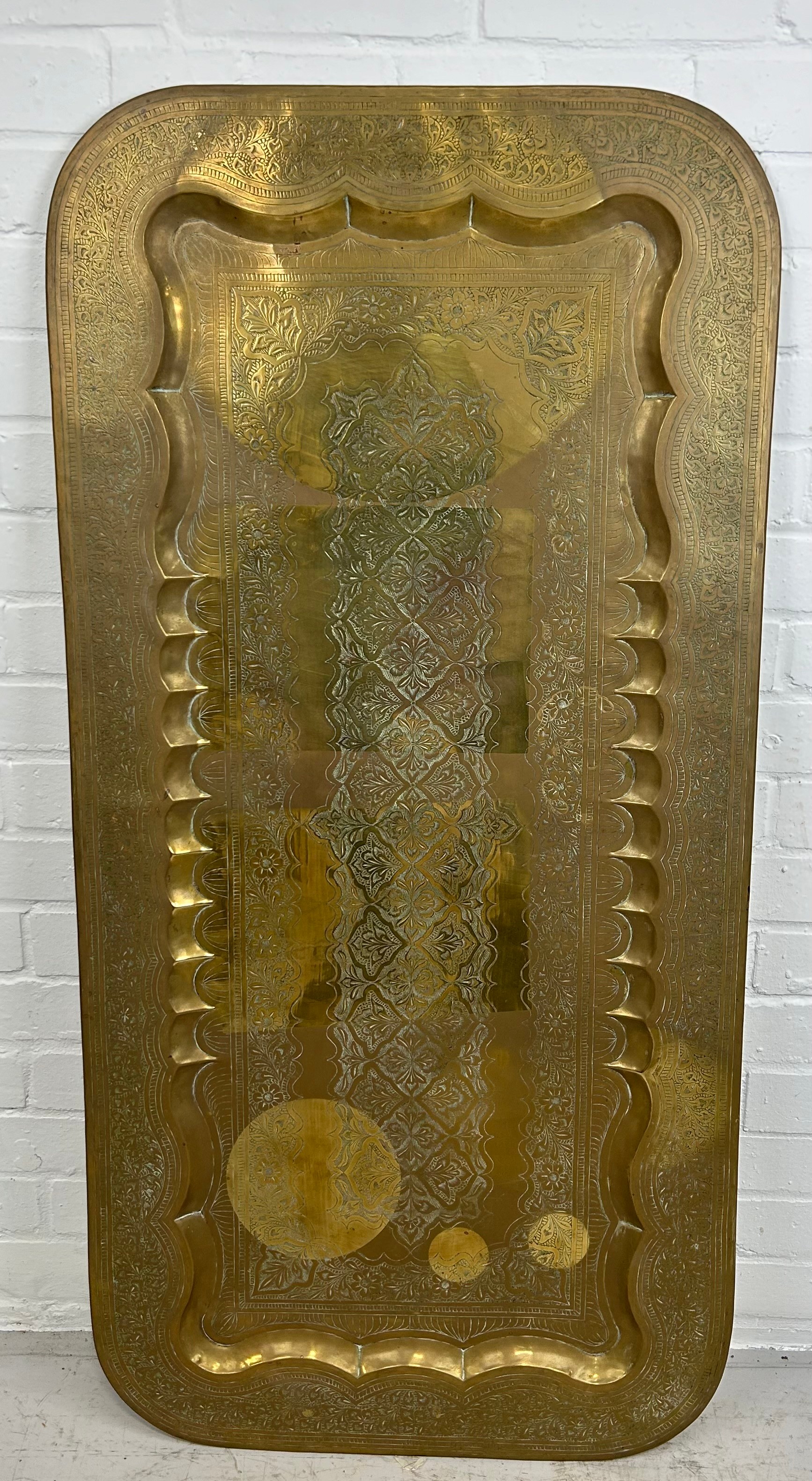 AN INDIAN BRASS TABLE TOP, 119cm x 58cm