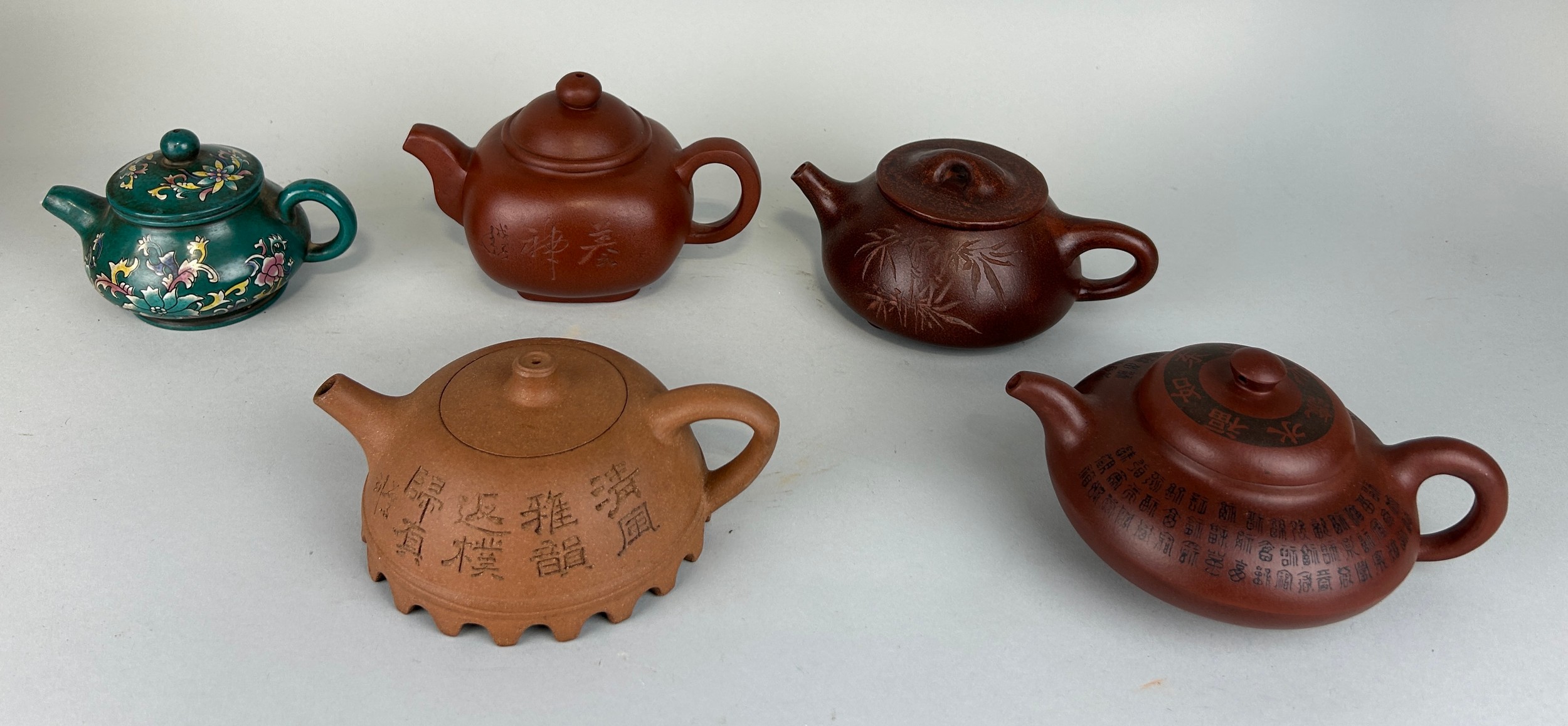 A COLLECTION OF CHINESE YIXING CLAY TEA POTS AND COVERS (5) All with seal marks to verso. Largest