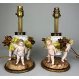 A PAIR OF DRESDEN PORCELAIN TABLE LAMPS, DEPICTING WINGED PUTTI, FLORA AND FAUAN, 29cm H each.