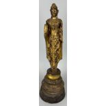 A CARVED GILT WOOD CARVED FIGURE OF A BUDDHA, Possibly 19th Century.