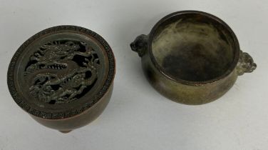 TWO CHINESE BRONZE INCENSE BURNERS (2)< One with lid, decorated with a dragon, on tripod feet (7cm x