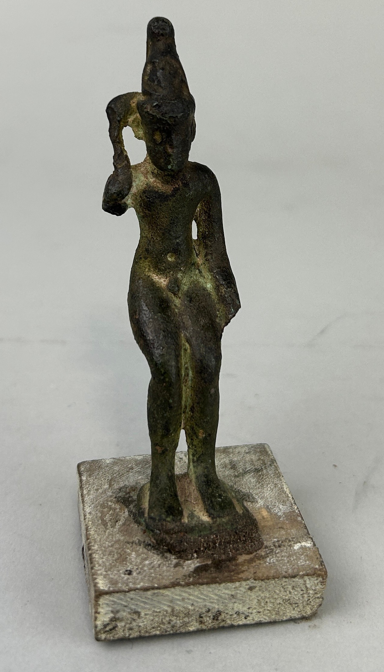 AN EGYPTIAN BRONZE STATUE POSSIBLY ANCIENT HARPOCRATES, 8.8cm H Including stand 10cm