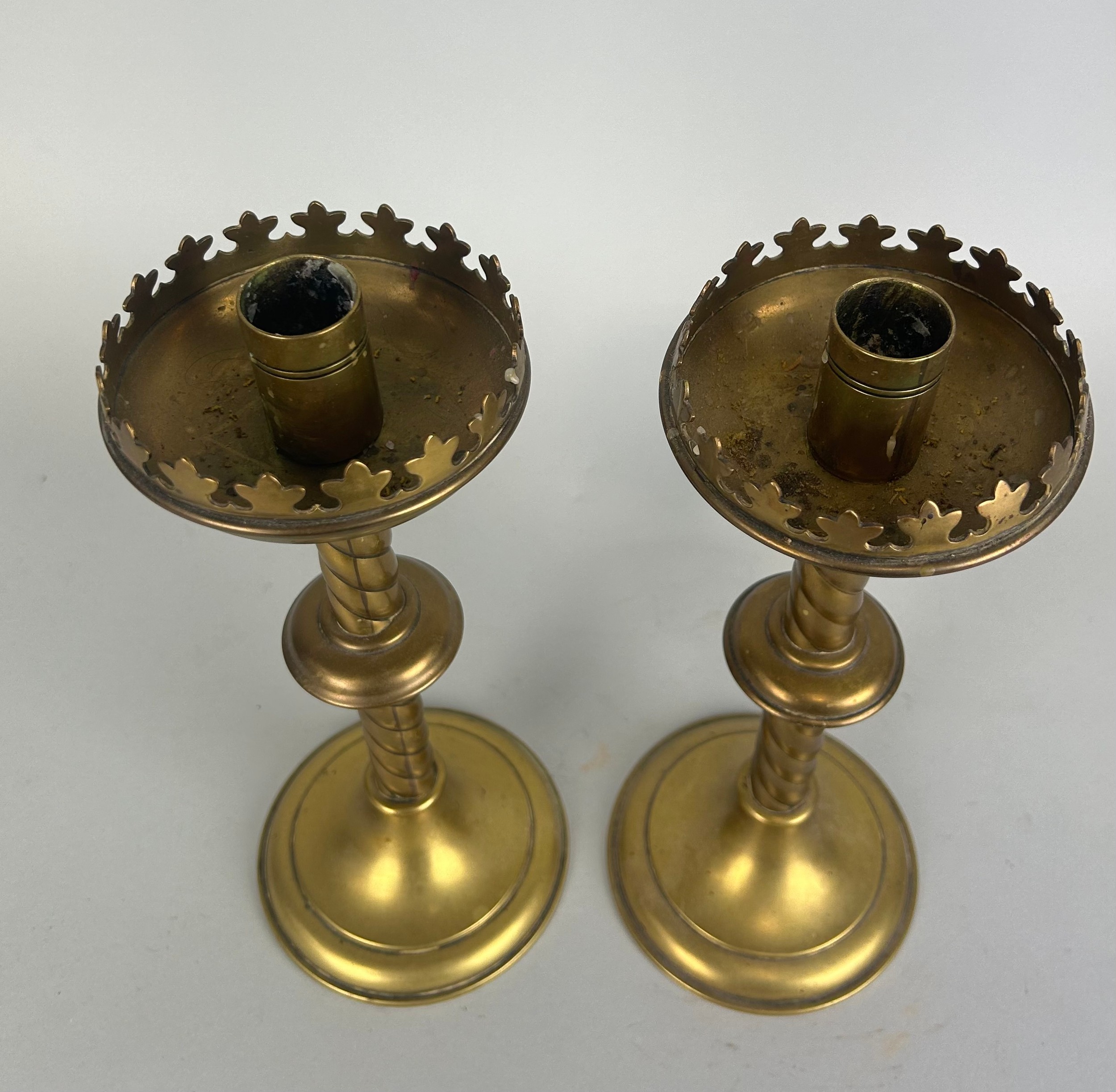 AFTER AWN PUGIN: A PAIR OF GOTHIC BRASS CANDLESTICKS 25cm H each. - Image 2 of 2