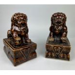 A PAIR OF BROWN GLAZED FOO DOGS (2), 25cm x 20cm each.