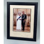 QUEEN ELIZABETH II AND PRINCE PHILLIP: A SIGNED PHOTOGRAPH DATED 2004 MOUNTED IN A SMYTHSON BLUE