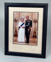 QUEEN ELIZABETH II AND PRINCE PHILLIP: A SIGNED PHOTOGRAPH DATED 2004 MOUNTED IN A SMYTHSON BLUE