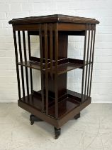 AN EDWARDIAN SHERATON REVIVAL TWO TIER REVOLVING BOOKCASE WITH MARQUETRY INLAID PATERA, 90cm x