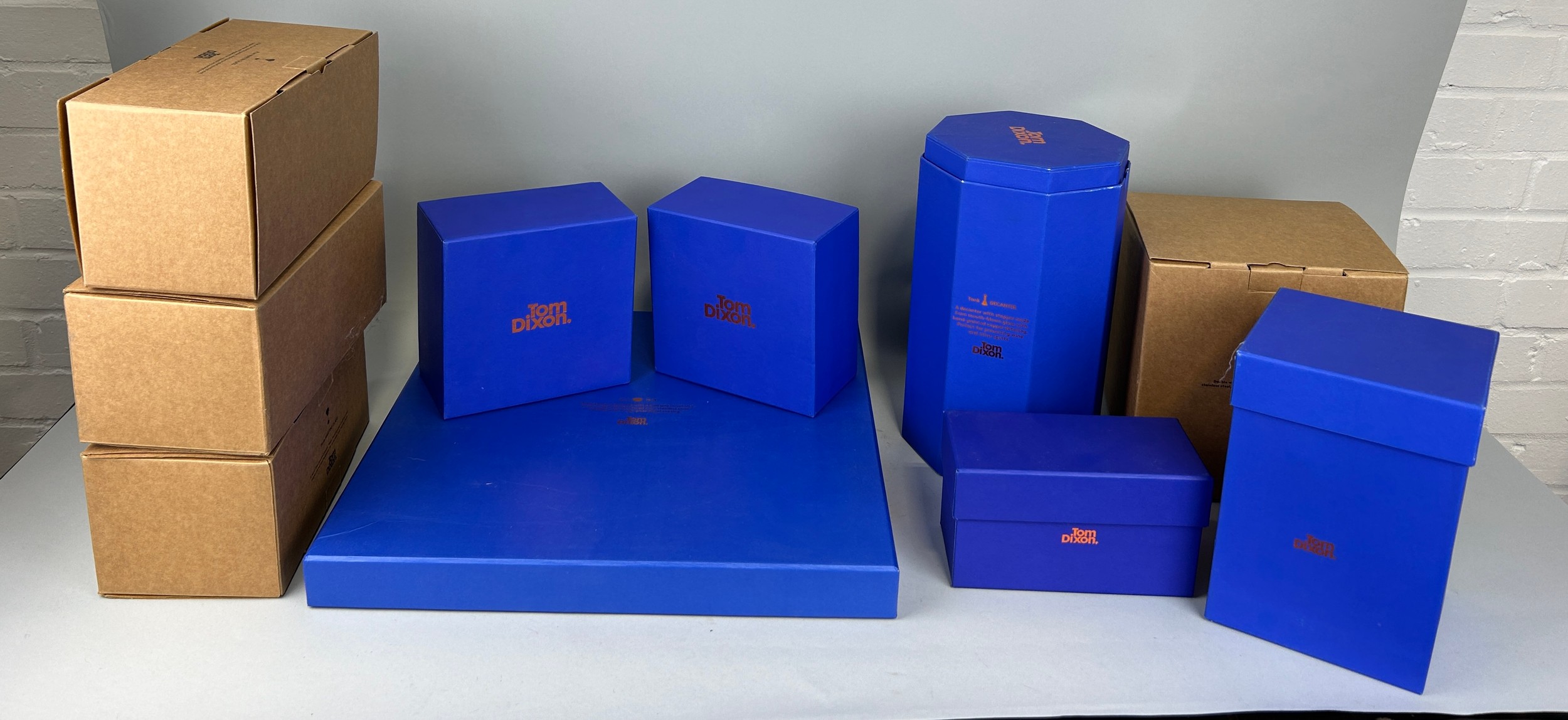 A COLLECTION OF TOM DIXON GLASSWARE AND METALWARE IN ORIGINAL PACKAGING (10 BOXES), To include six