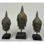 A SET OF THREE THAI BRONZE BUDDHA'S POSSIBLY 18TH OR 19TH CENTURY, Each mounted on stand. Largest