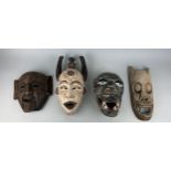 A GROUP OF FOUR AFRICAN TRIBAL MASKS (4),