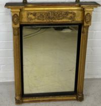 A REGENCY GILT WOOD WALL MIRROR, 73cm x 55cm Corinthian columns, with carved oval patera.