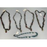 A GROUP OF FOUR POLYCHROME MOSAIC GLASS BEAD NECKLACES, HELLENISTIC TO ISLAMIC PERIOD CIRCA 4TH