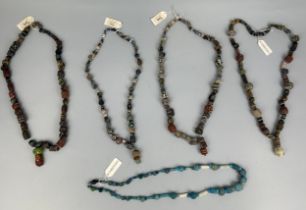 A GROUP OF FOUR POLYCHROME MOSAIC GLASS BEAD NECKLACES, HELLENISTIC TO ISLAMIC PERIOD CIRCA 4TH
