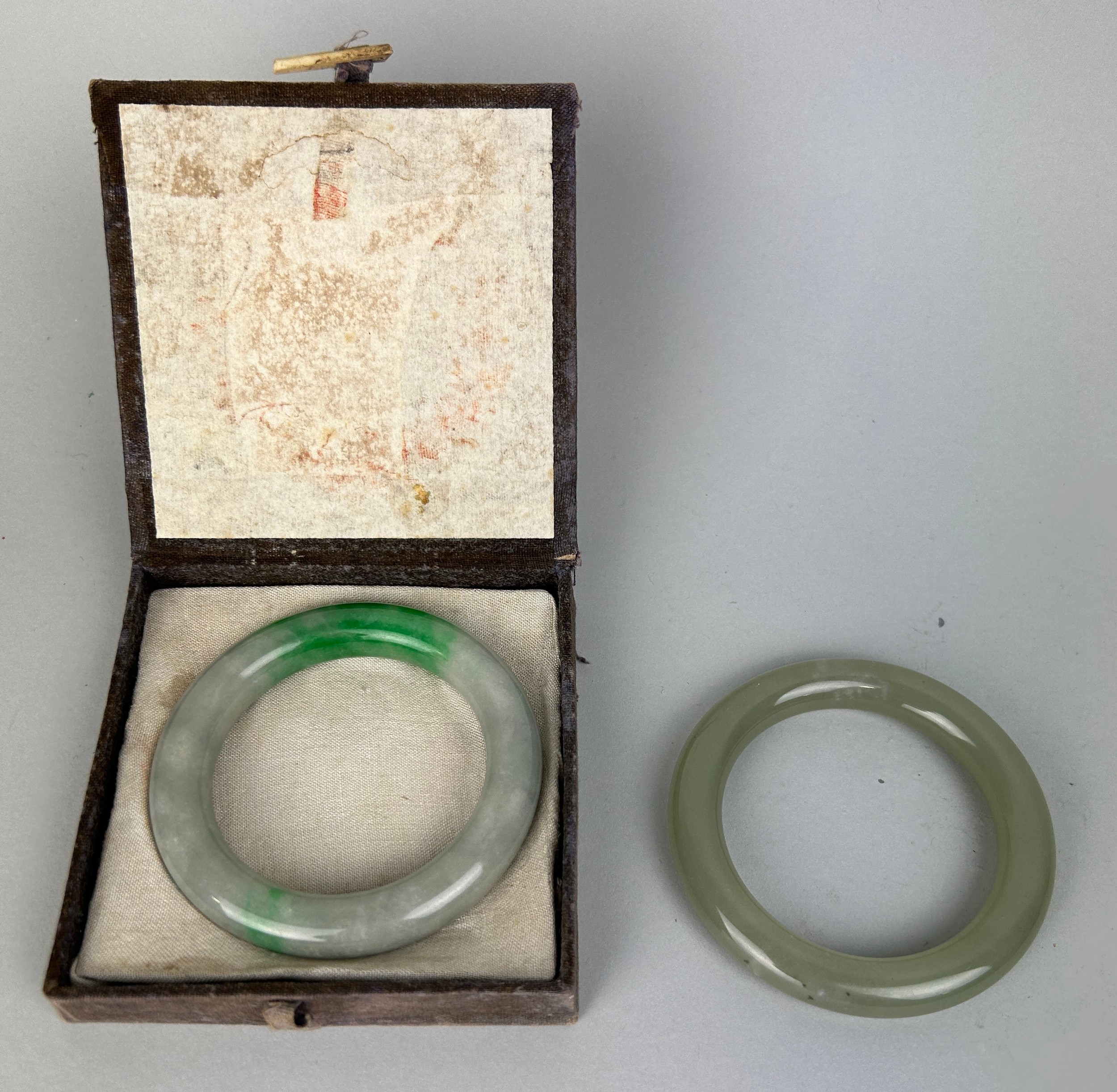 TWO CHINESE JADEITE AND JADE BANGLES (2), 8cm diameter.