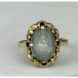 A SMALL GOLD RING SET WITH A BLUE STONE, Possibly aquamarine. Weight 2.3gms