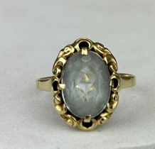 A SMALL GOLD RING SET WITH A BLUE STONE, Possibly aquamarine. Weight 2.3gms