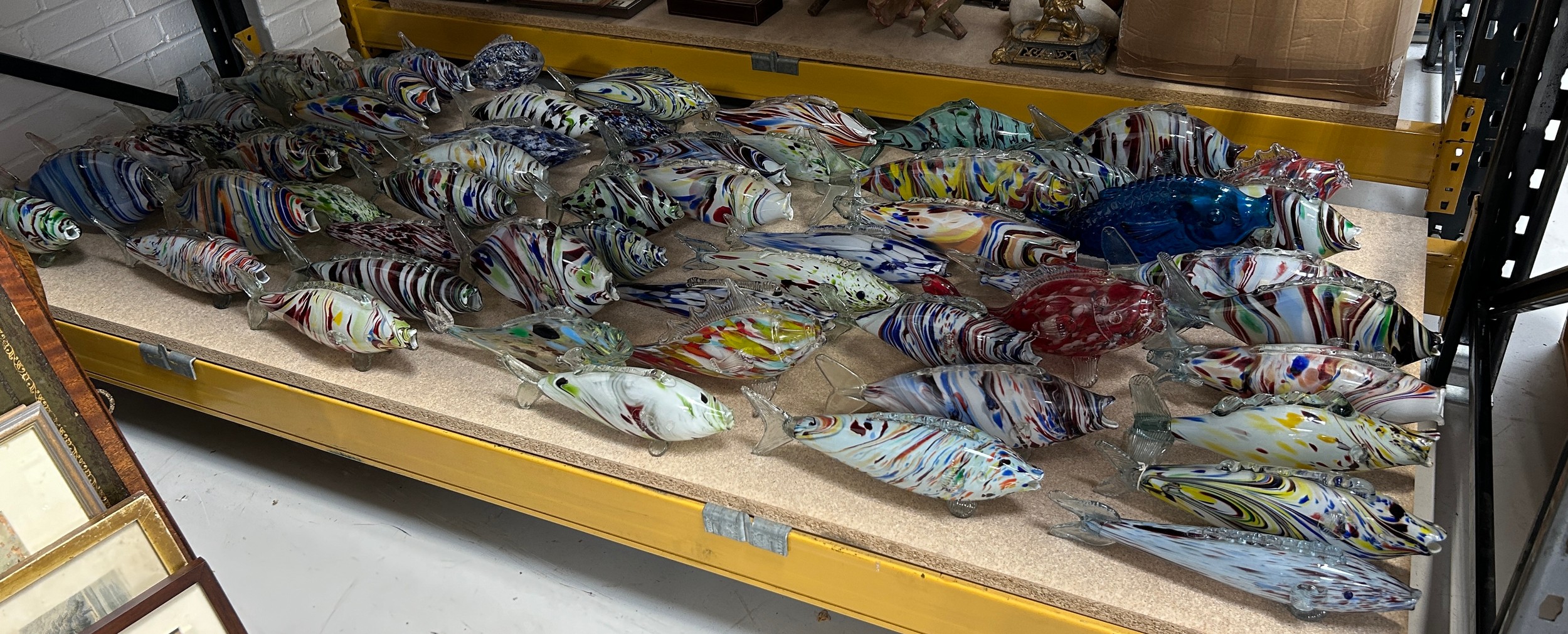 A COLLECTION OF FIFTY EIGHT MEDIUM SIZED GLASS FISH (58) Largest 45cm L