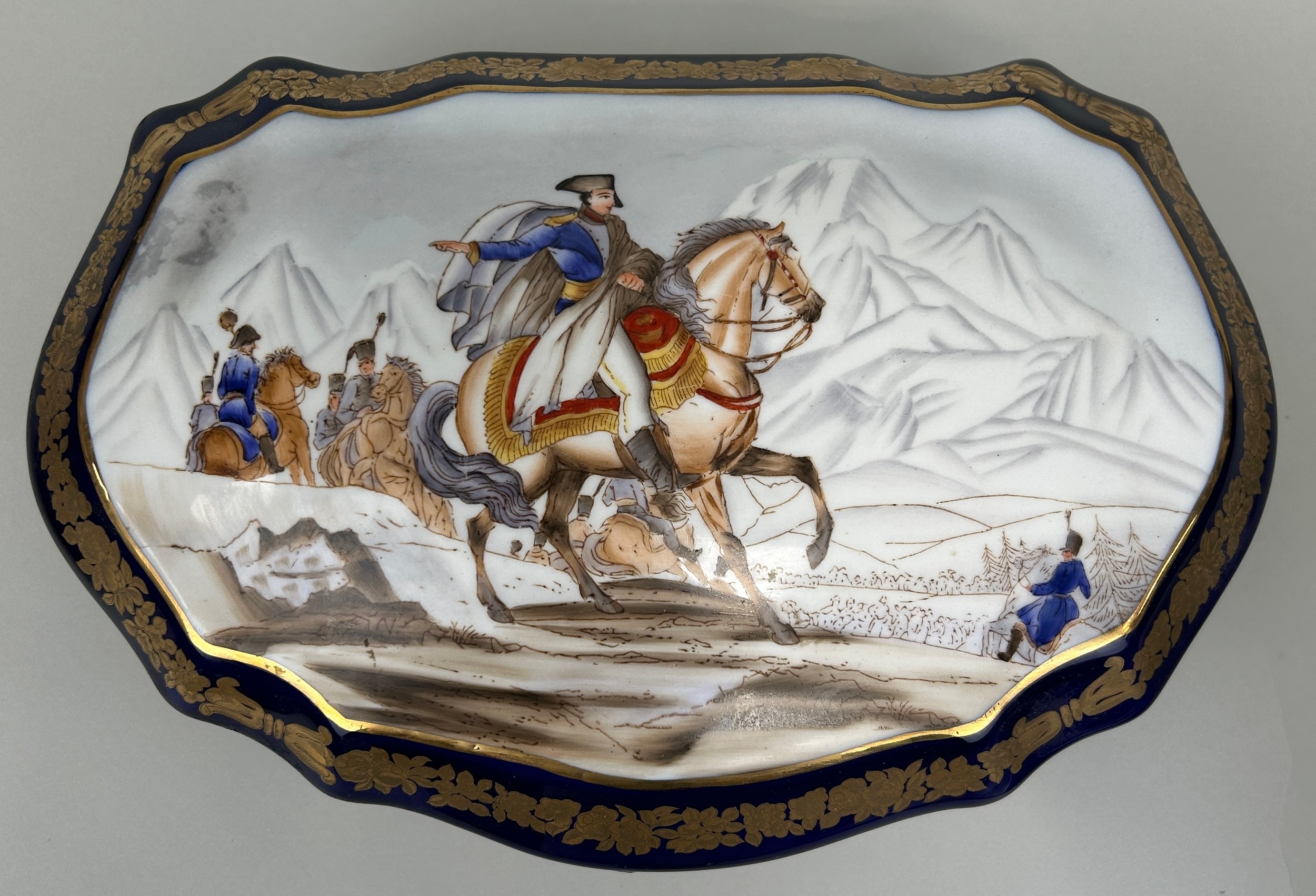 AFTER SEVRES: A SEVRES STYLE PORCELAIN BOX DECORATED WITH A HORSE AND RIDER, WITH GILT EAGLES.