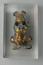 A PRE-COLUMBIAN TUMBAGA FROG ORNAMENT, 3.3cm x 2cm Mounted on perspex stand. 4.5cm x 3cm